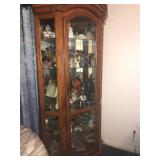 GLASS SIDES AND FRONT CURIO CORNER CABINET FILLED WITH FIGURINES