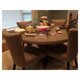 Large round dining table with dining chairs