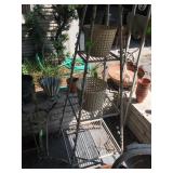 Patio and Yard filled with furniture, birdbaths, benches 