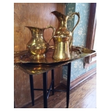 Black laquer table and large brass serving pieces