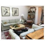 Den with couches, coffee table and artwork