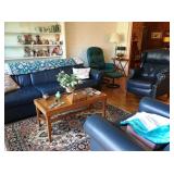 Blue leather sofa and chairs; dolls and steins