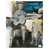 Guitar-playing cowboy and dog statue