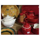 Red serving pieces, milk glass and colorful plates
