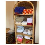 Wicker shelf full of linens
