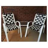 Stacking woven patio chairs and matching glass side tables