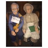 Gram and gramps dolls on a bench with porcelain heads and hands and feet