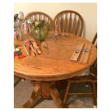 Round oak kitchen table and four chairs, great condition