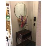 Round Beveled Heavy Hanging Mirror, Small Cherry Wood Table with pull out, Silk Flowers.