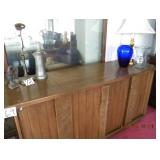 large buffet w storage collectibles on top.