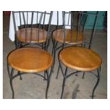 4 wrought iron chairs with wood seats. 