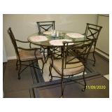Metal table with glass top and 4 chairs on casters