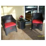 Pair of wicker style chairs with ottomans and side table