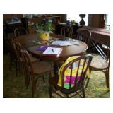 Claw foot dining table with 6 cane bottom chairs and 3 leaf