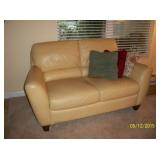 Butter colored leather loveseat