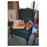 Wing chair, books