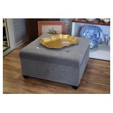 Large gray fabric ottoman, artwork