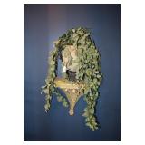 Artificial plant on sconce