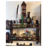 Vases and candle holders on a wall shelf