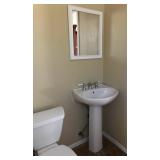 Bathroom cabinets, pedestal sink, lighting