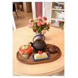 there is a teapot collection, china hutch and dining tables