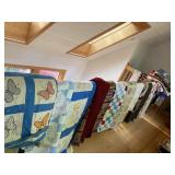 piles of finished and unfinished antique and vintage quilts