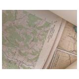piles of maps and charts