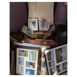 piles of unsorted framed works