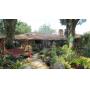 Legacy Estate Solutions presents a beautiful house surrounded by a botanical extravaganza 