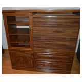 Wooden entertainment center with roll top compartment