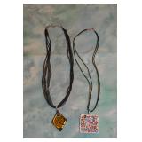 Cord necklaces with gold and silver pendants