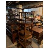 Stacks of various small tables and ottomans