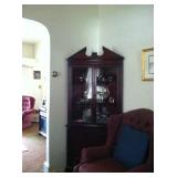 Textured armchair and corner china cabinet.