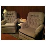 Two of three matched neutral armchairs.