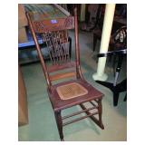 Slim rocker with cane seat.