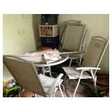 Patio set for four with glass topped table and umbrella.