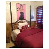 Full-sized bed with unusual tall metal headboard