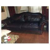 Black leather sofa with wood accents