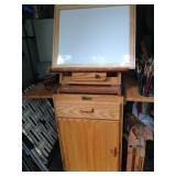 Easel cabinet loaded with brushes and paints