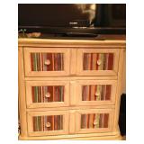 Three-drawer chest with fabric inlay.