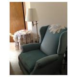 Armchair, floor lamp and small table.