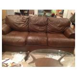 Brown leather sofa bed.