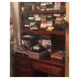 Desk with bookshelf, currently loaded with VHS tapes.