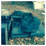 Approximately 50 pieces of polished black granite.