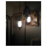 Three-fixture floor-to-ceiling lamp.