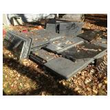 Huge cache of polished black granite slabs.