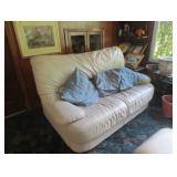 White leather loveseat. there is a matching chair.
