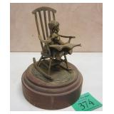 METAL SCULPTURE OF A CHILD IN A ROCKING CHAIR WITH DOG AND BOOK. VERY DETAILED, 3 3Photo Description