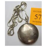 STERLING SILVER LOCKET PENDANT AND CHAIN. 1.25" DIAMETER. SMALL DENT ON EDGE FROM OPENING
