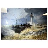THIS IS A CLOSEUP OF A CLAUDE MONET PRINT OF THE SEA AND A LIGHTHOUSE